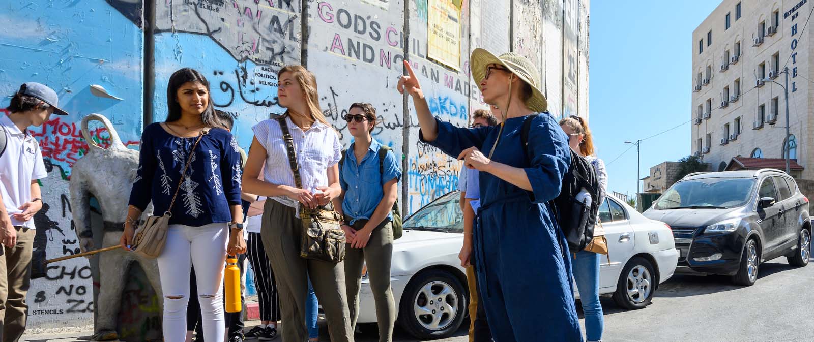 A teacher with students walks around Jerusalem.