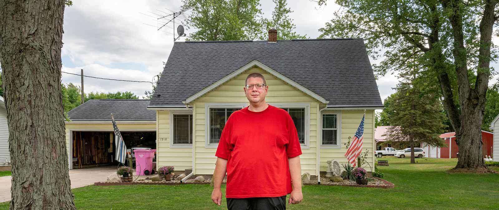 Andy Royer stands outside his parents home.