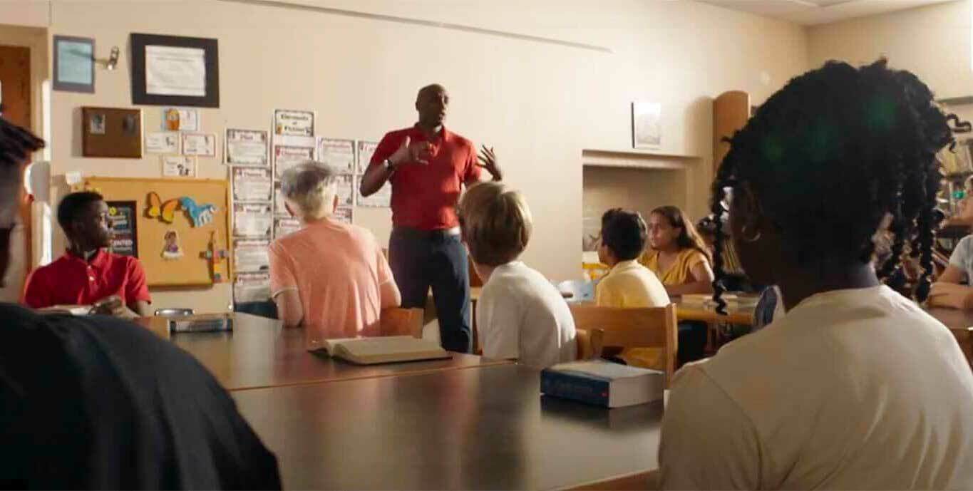 A man stands in front of a classroom.