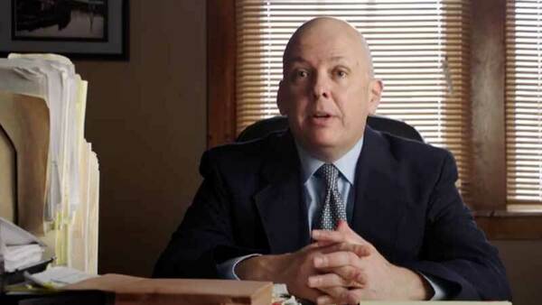 Robert Johns sitting at a desk.