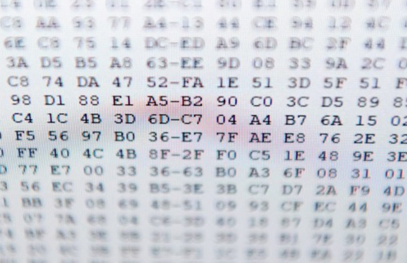 A close-up, out-of-focus shot of a screen displaying a series of hexadecimal code.