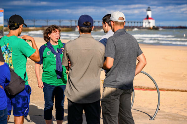 Professor Jane Cleland-Huang talks to her team on the beach.