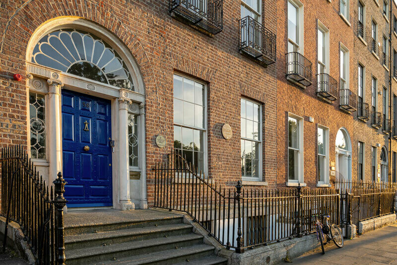 The front of the Notre Dame-owned O'Connell House in Dublin, with its distinctive dark blue door and red brick facade.