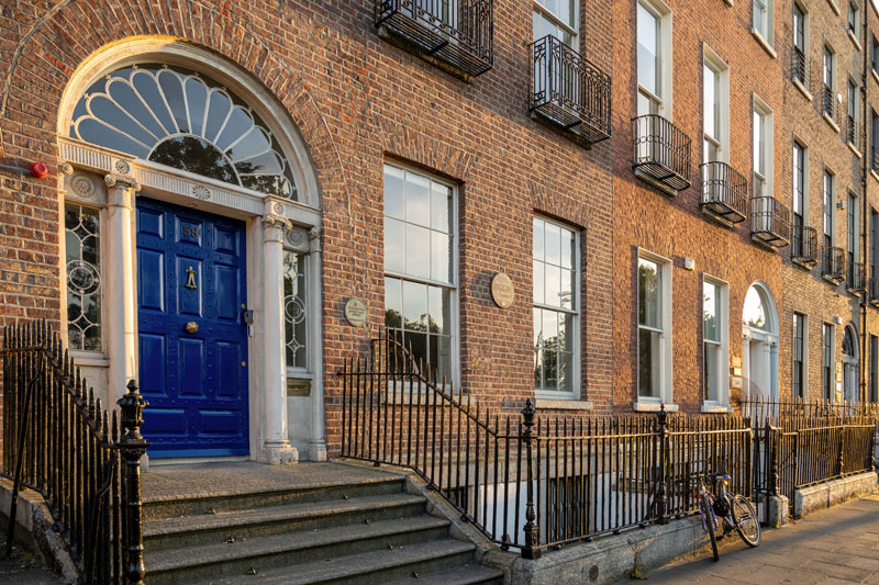 The front of the Notre Dame-owned O'Connell House in Dublin, with its distinctive dark blue door and red brick facade.