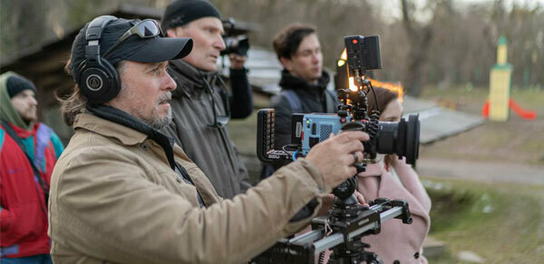 Four males and one female using video equipment.