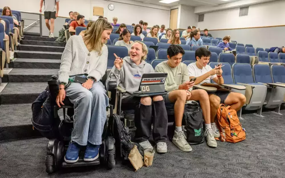Annie Hamilton in class with three of her friends, one female and two males.