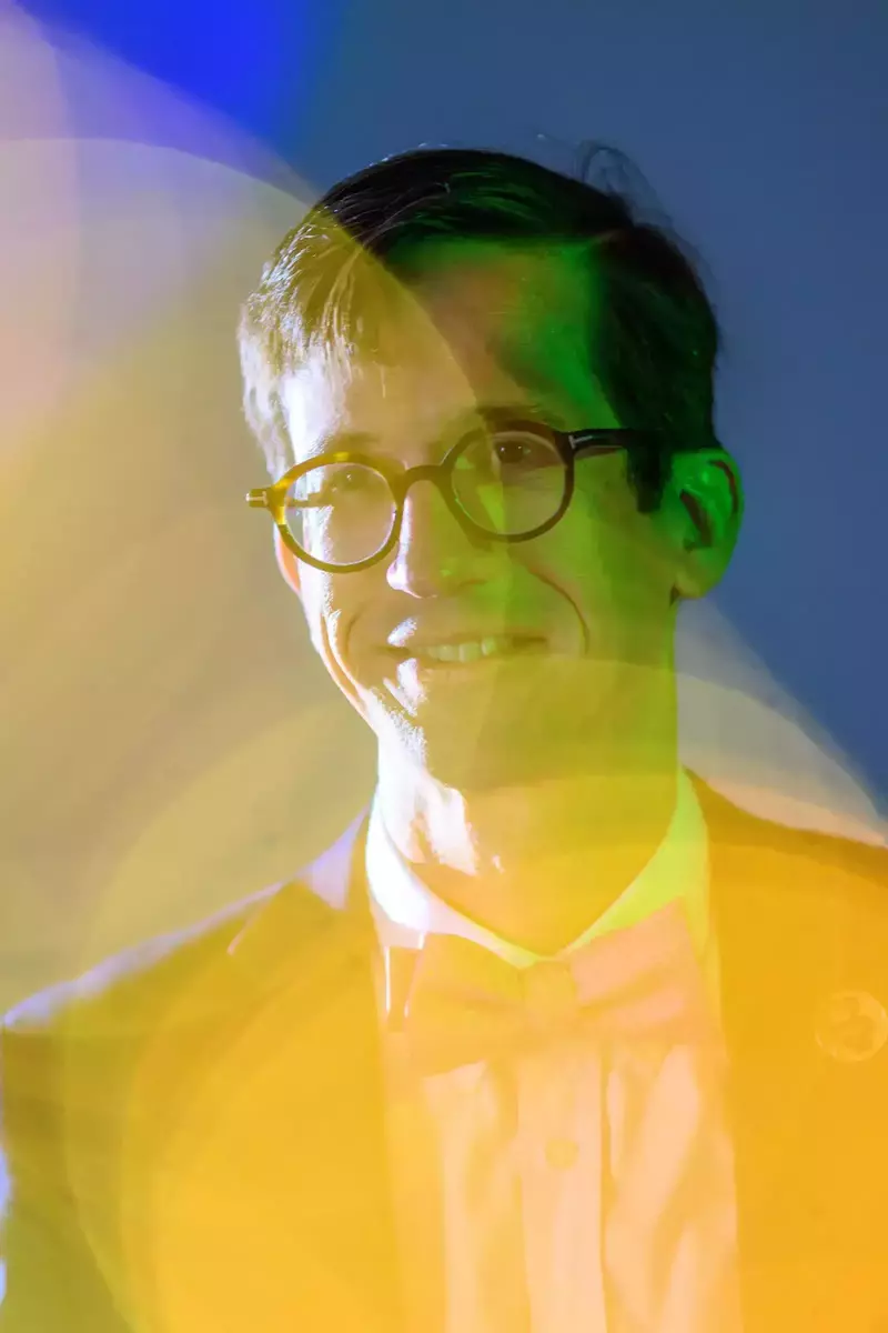 A portrait of Santiago Schnell, with him a blurry yellow foreground.