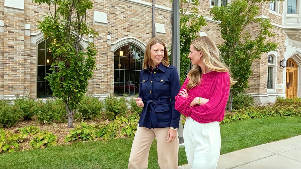 Micki Kidder stands to the left of Jenna Liberto outside of a brick building at Notre Dame