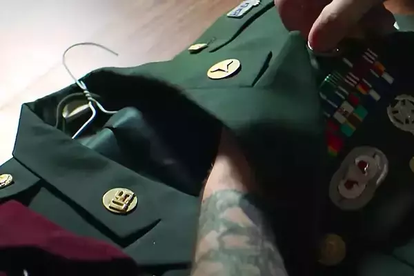 A Notre Dame football player, wearing a gold helmet and a blue jersey with the number 90, gives a thumbs-up on the field. Text overlay reads, "Fighting To Serve Others Above Self."