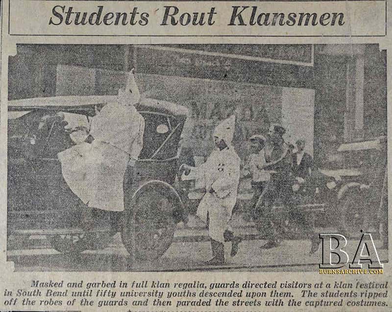 A newspaper clipping, with a photo of students wearing Klan robes, captioned: 'Masked and garbed in full klan regalia, guards directed visitors at a klan festival in South Bend until fifty university youths descended upon them. The students ripped off the robes of the guards and then paraded the streets with the captured costumes.