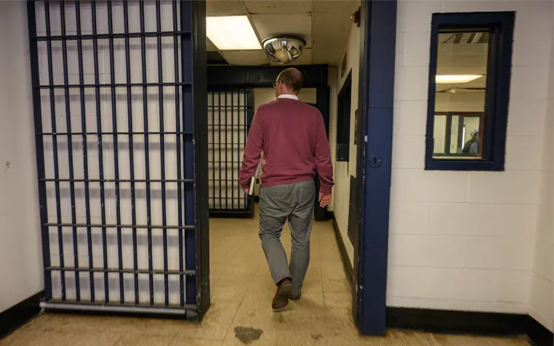 Brian O' Conchubhair enters the Westville Correctional Facility through cell doors.