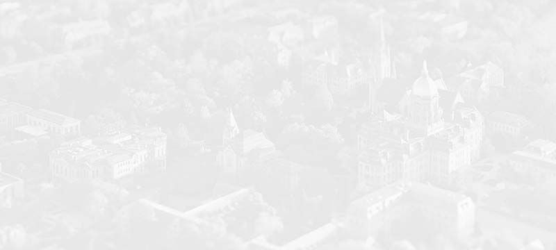 A faded grayscale aerial photo of Notre Dame's campus.