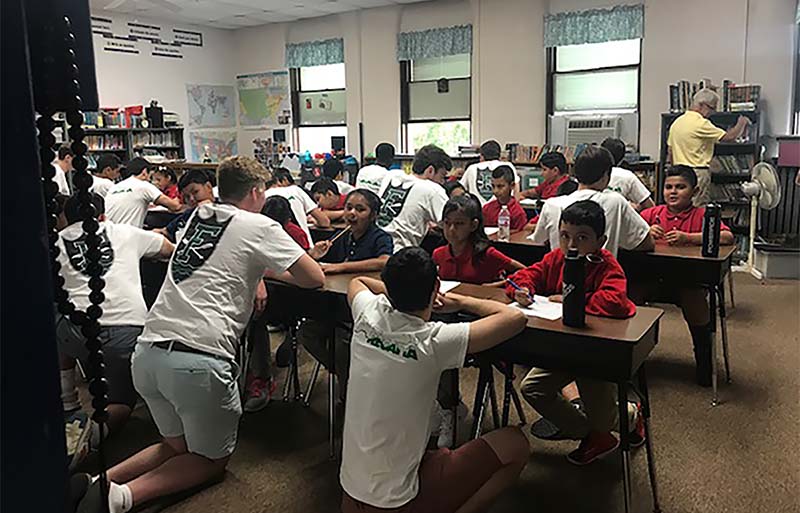 Fisher Hall students in a classroom with St. Adalbert students.