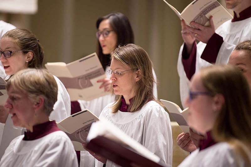 Elaine Stratton Hild, surrounded by fellow choir members, sings the Medieval chants in the Schola Concert.