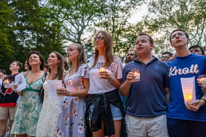 Vice President for Student Affairs Rev. Gerry Ollinger, C.S.C., in front of a crowd of students, says a blessing during the Seniors&rsquo; Last Visit to the Grotto during Senior Week 2025.