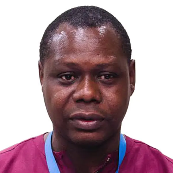 A professional headshot of a man with dark skin wearing a deep red scrub top and a light blue lanyard.