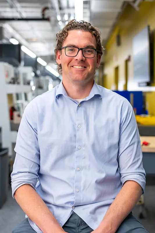 David Richter smiling with out of focus hangar in the background.