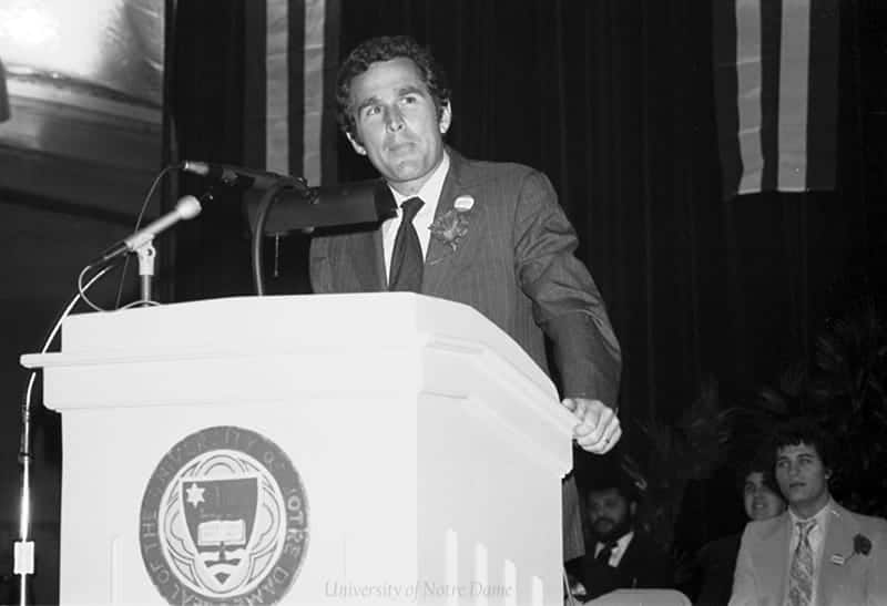 Bush stands at a podium with the Notre Dame seal on the front of it.