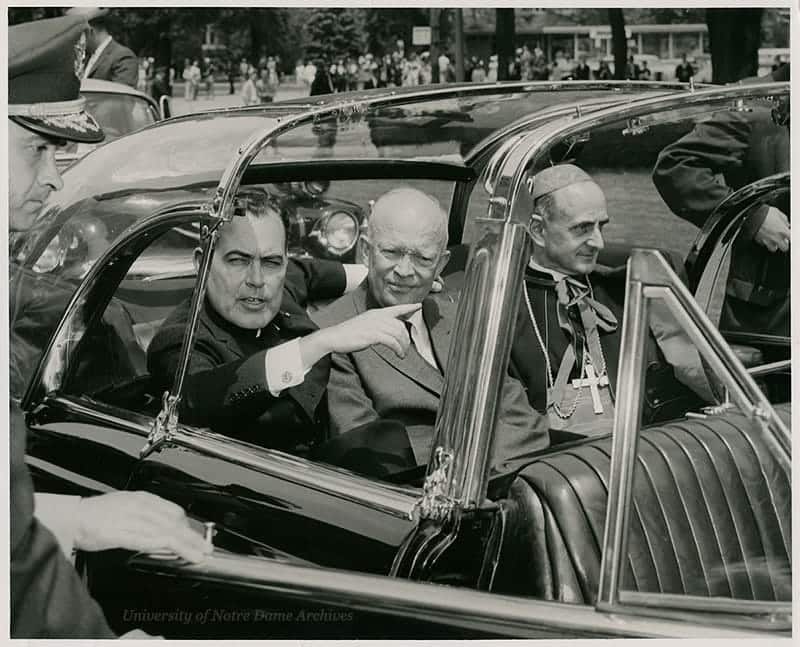 Father Hesburgh, Eisenhower and Cardinal Montini ride in the backseat of a car.