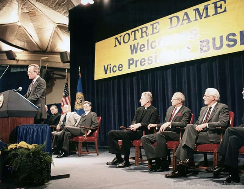 Bush speaks at a podium in front of a sign that reads Notre Dame Welcomes Vice President Bush.