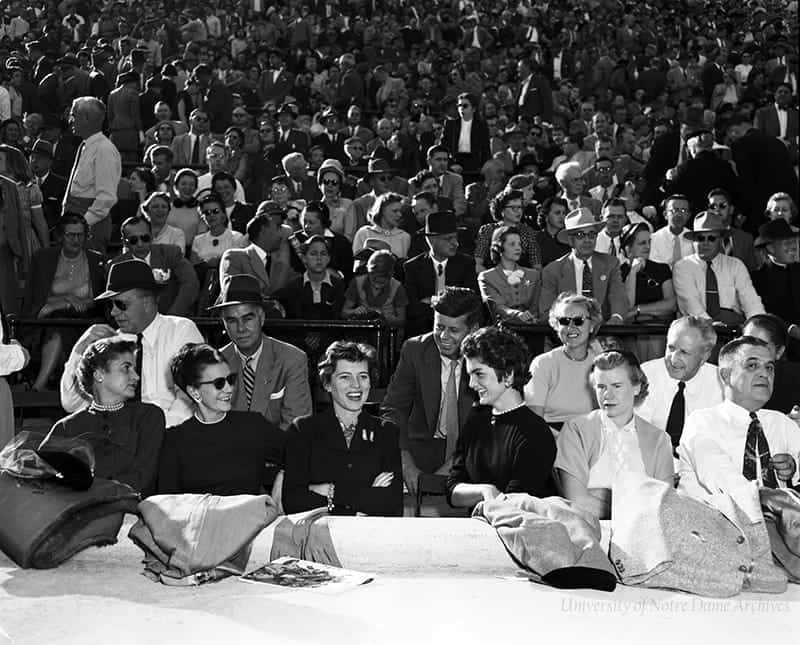 A crowded football stands with Kennedy and his wife Jacqueline in attendance.