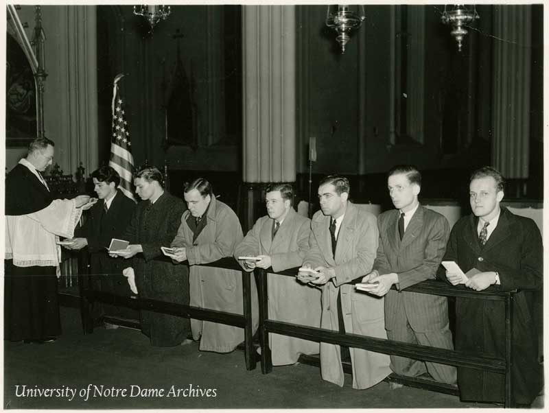 A group of male students leaving Notre Dame to join the military at a special prayer service in the Basilica of the Sacred Heart, 1941.