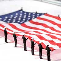 ROTC cadets and midshipmen hold an oversize U.S. Flag during the national anthem at Compton Family Ice Arena. January, 2016.