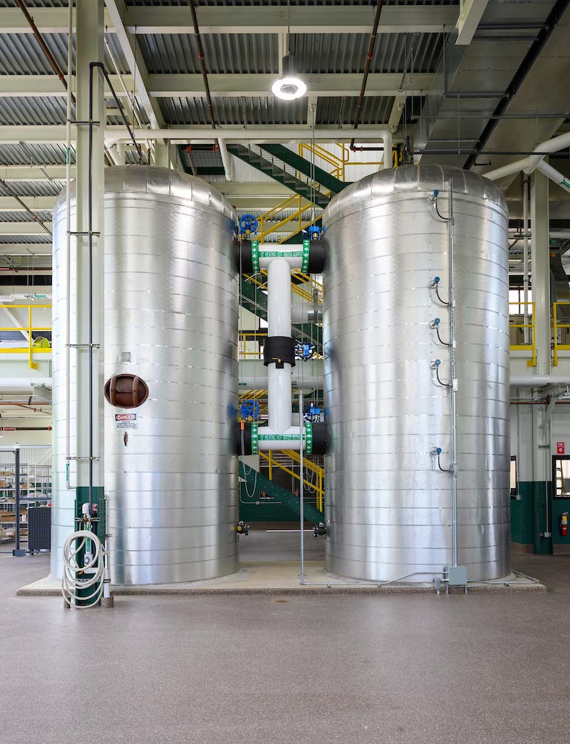 Two large silver containers in the Utilities East Plant.