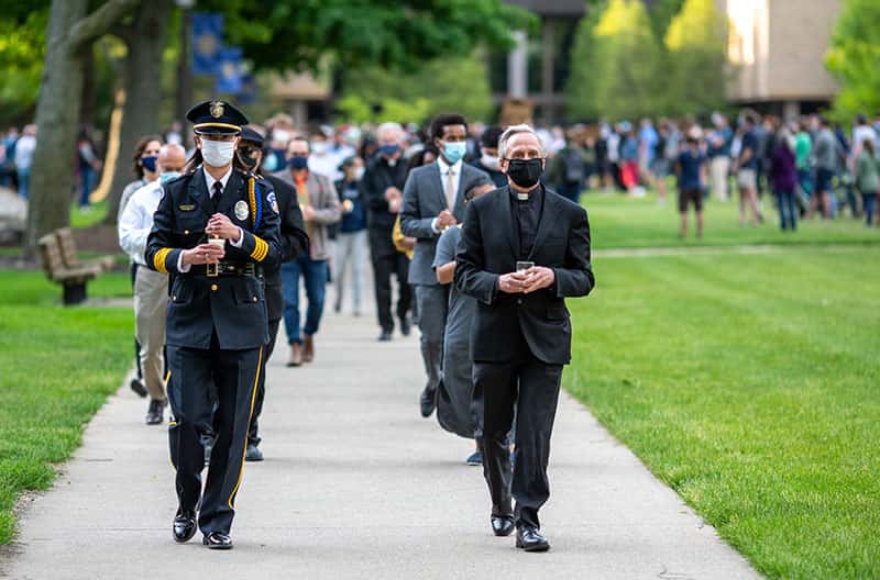 Father Jenkins and Shibata lead a group people.