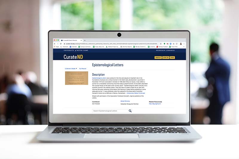 The webpage of CurateND that displays the Epistemological Letters collection on a laptop in an office.