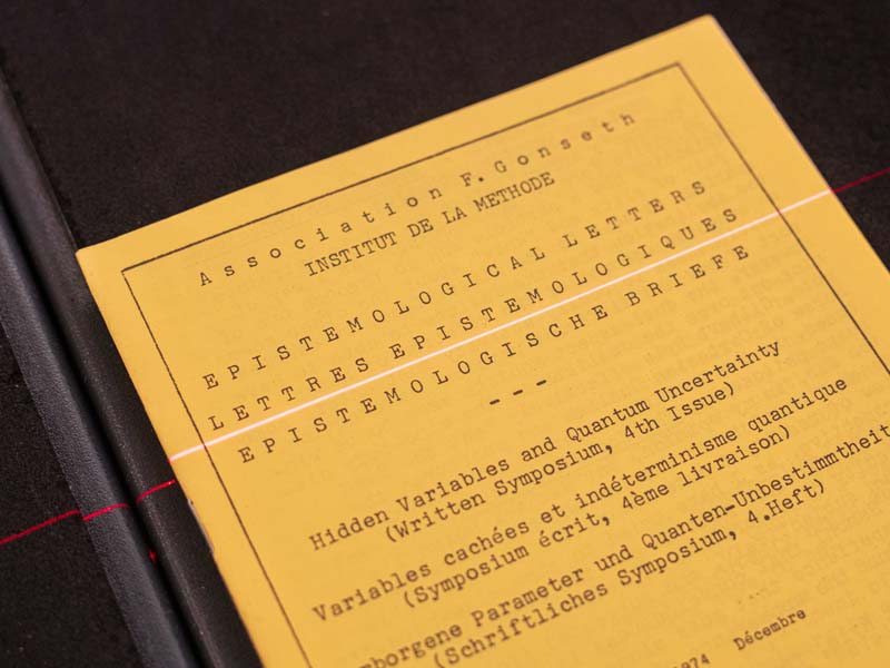 A close up of the cover of Epistemological Letters with red scanner laser.