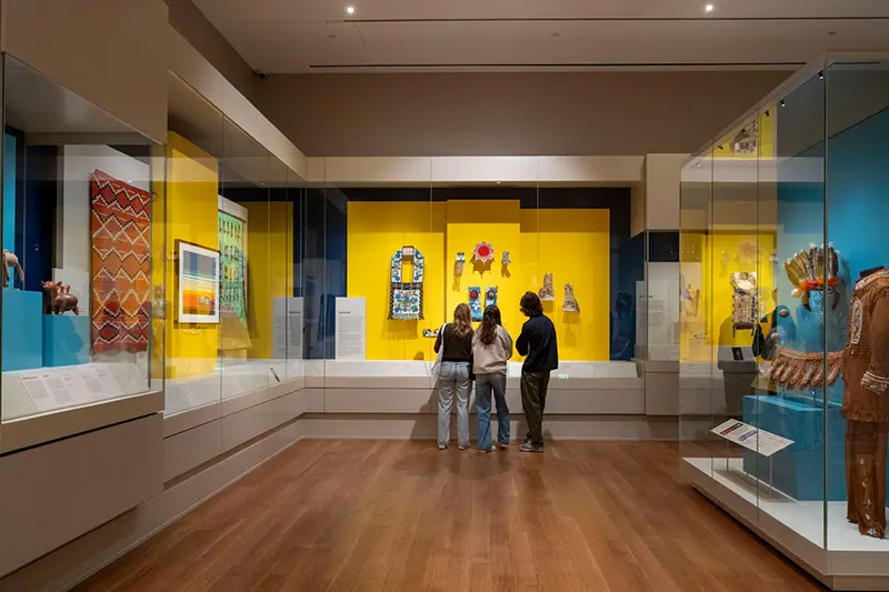 Three students viewing an exhibit in Raclin Murphy Museum of Art