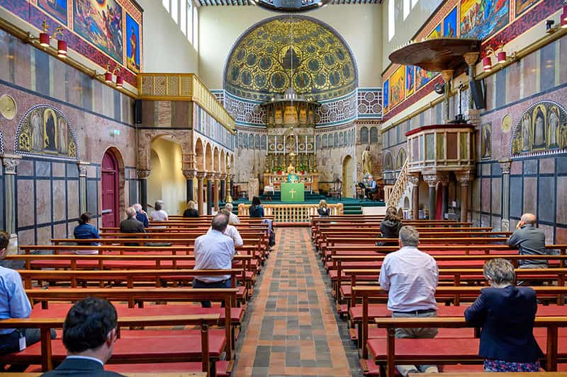 People standing in church pews.