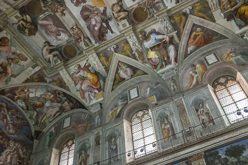 Ceiling of the Sistine Chapel showcasing many of Michelangelo&rsquo;s frescoes depicting several Old Testament scenes.