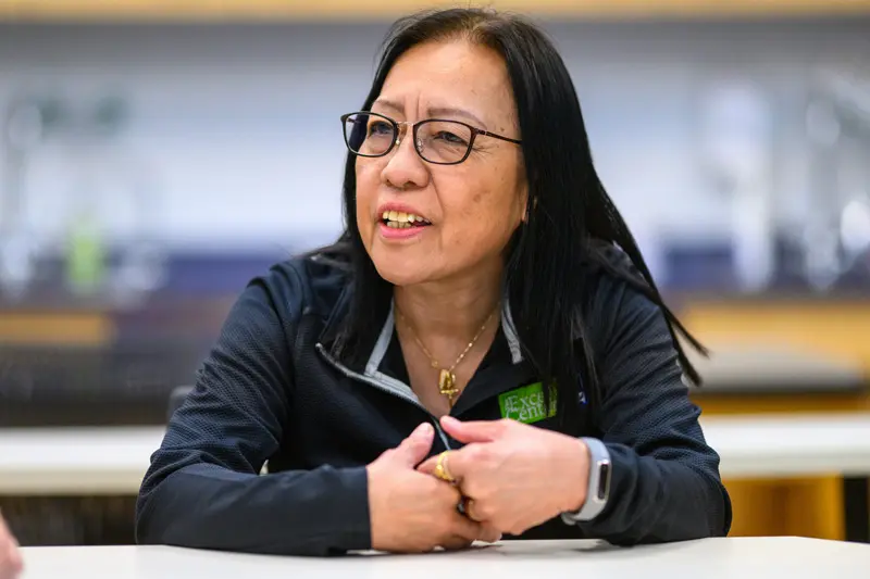 Connie De Castro sits at a table talking to someone off camera.