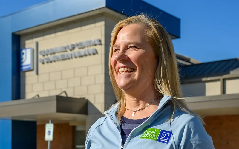 A portrait of Betsy Delgado in front of The Excel Center in Indianapolis.