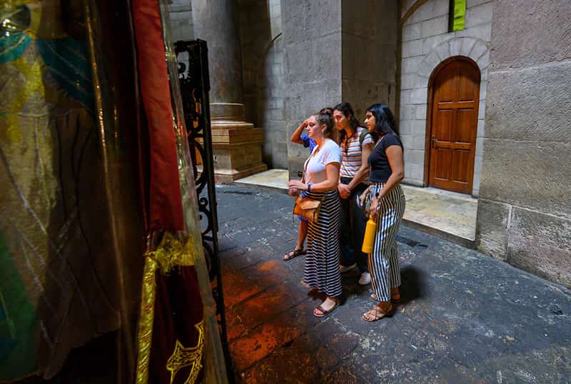 A small group of students observe a shrine.