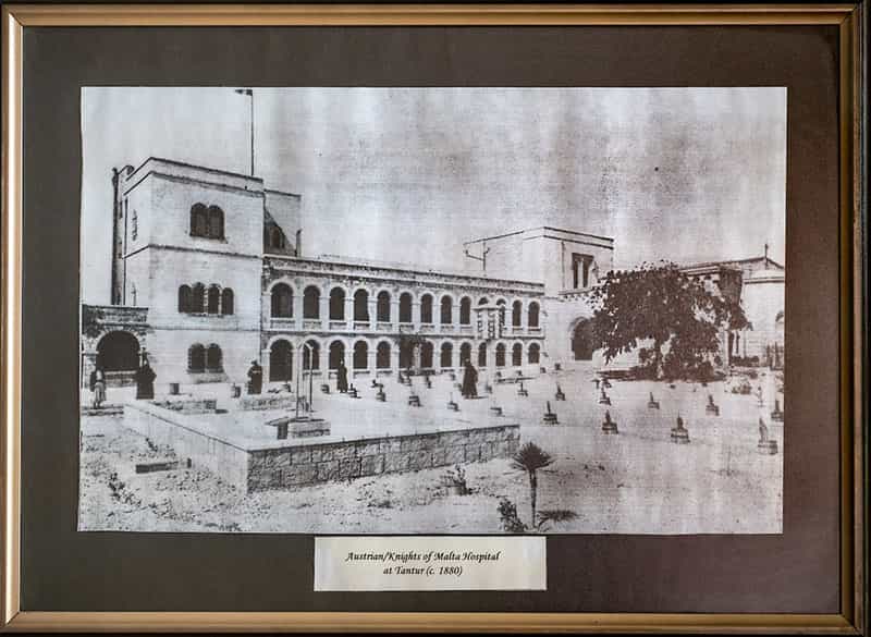 A framed black and white photo of a building.