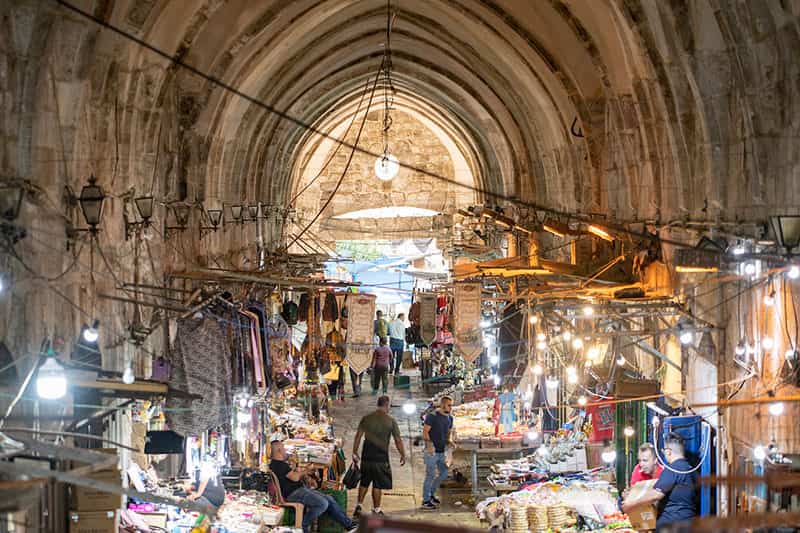 Street shops set up in an dimly lit alley.