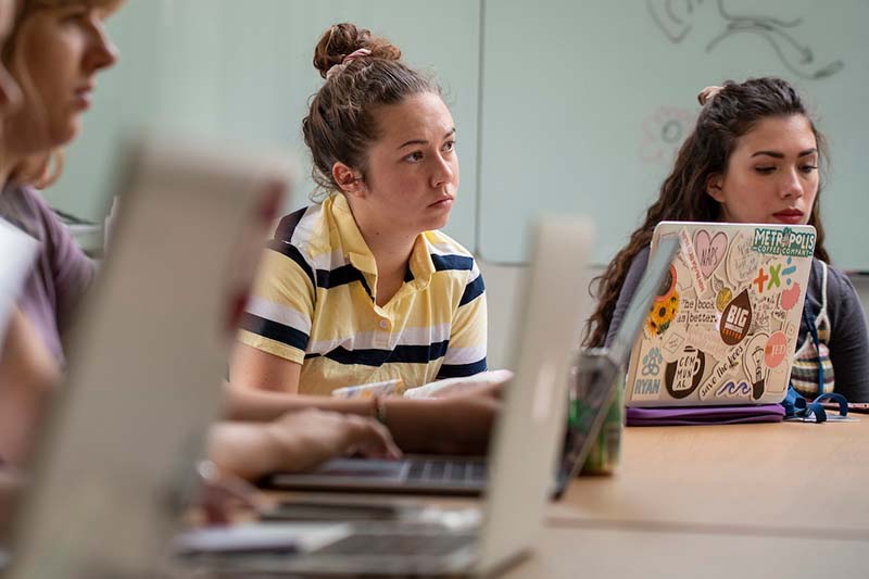 A female student speaks in a classroom.