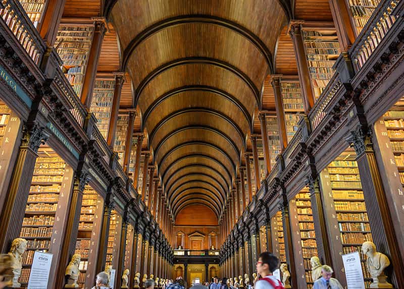 People browse in a library full of books from the ground up.
