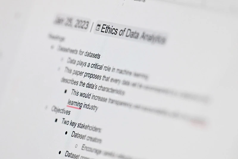 A laptop screen with a document about the Ethics of Data Analytics and notes on transparency and the learning industry.